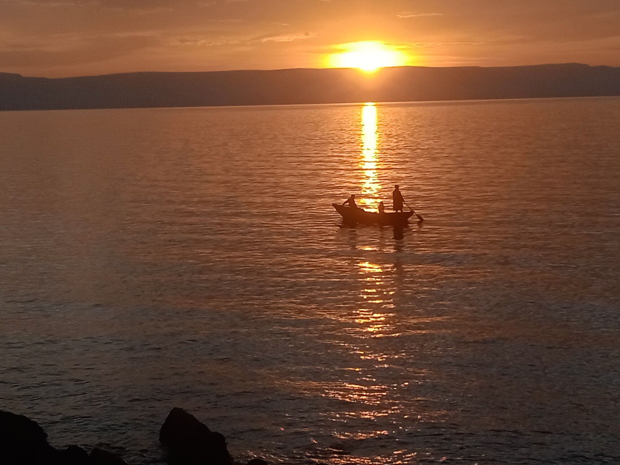 A fishing canoe on Lake Tanganyika at sunset